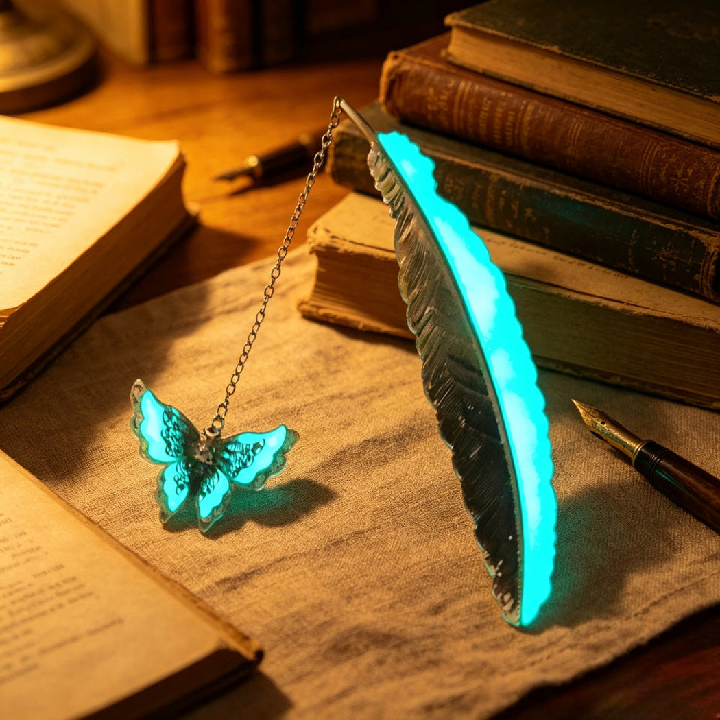 Glowing cyan feather bookmark with butterfly charm on a vintage writing desk