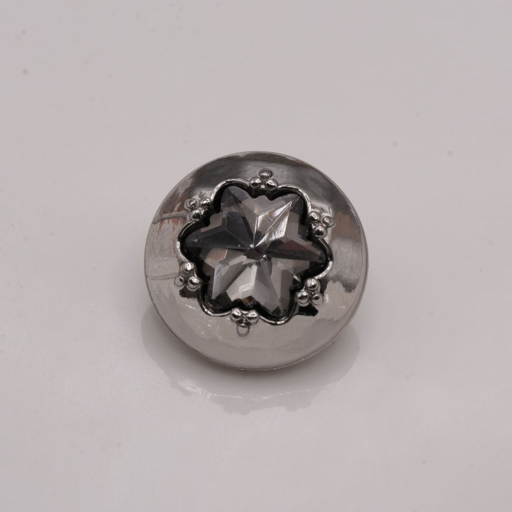 Smoky-gray star-center button with a silver-tone round rim