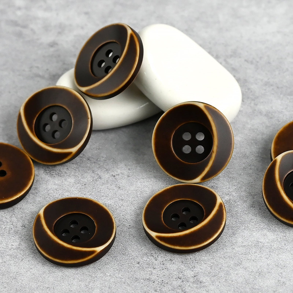Deep brown four-hole buttons with sweeping crescent grooves