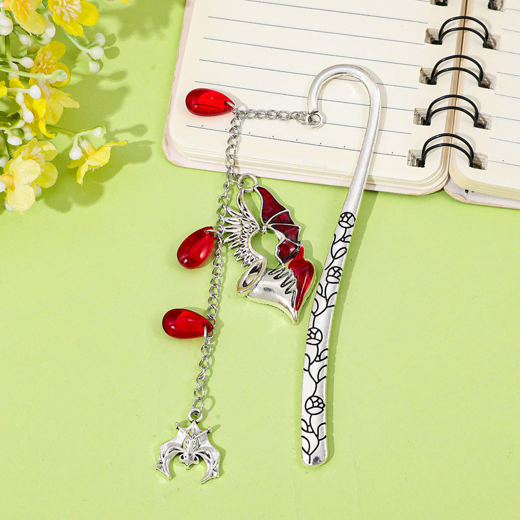 Gothic red charm bookmarks in a reading scene