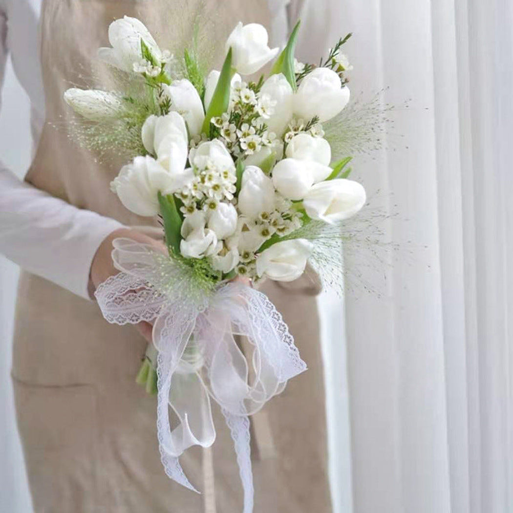 White lace ribbon wrapped around a flower bouquet