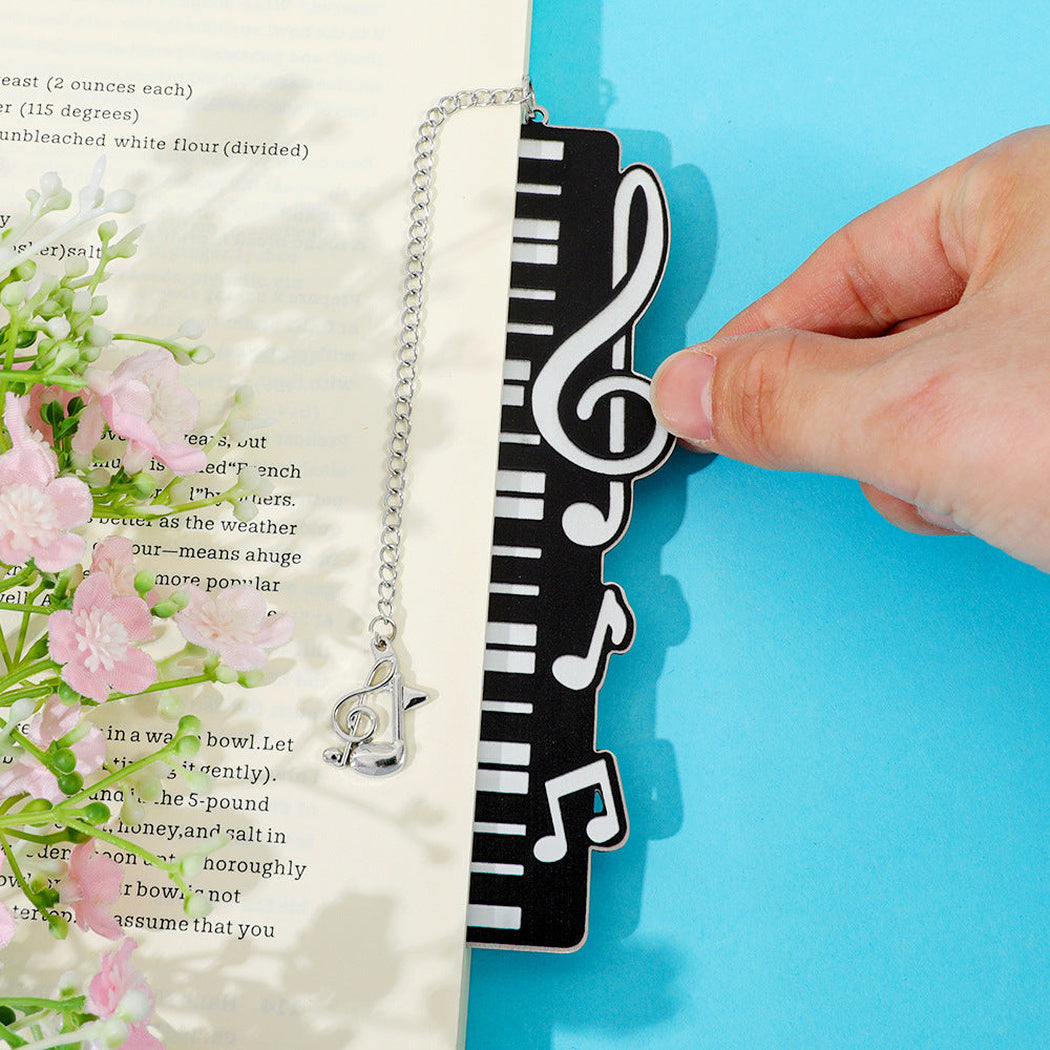 Piano key bookmark resting on an open book