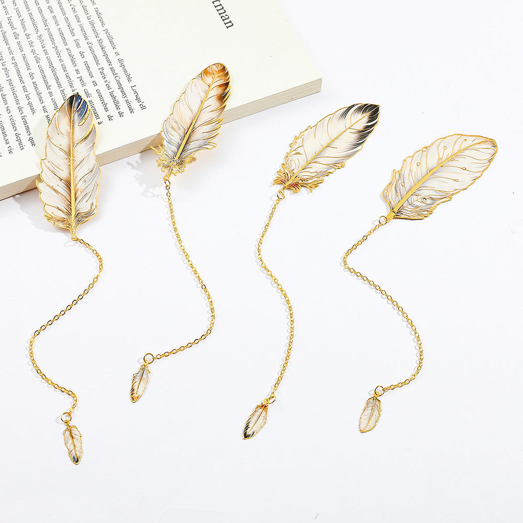 Four feather bookmarks arranged on a white page