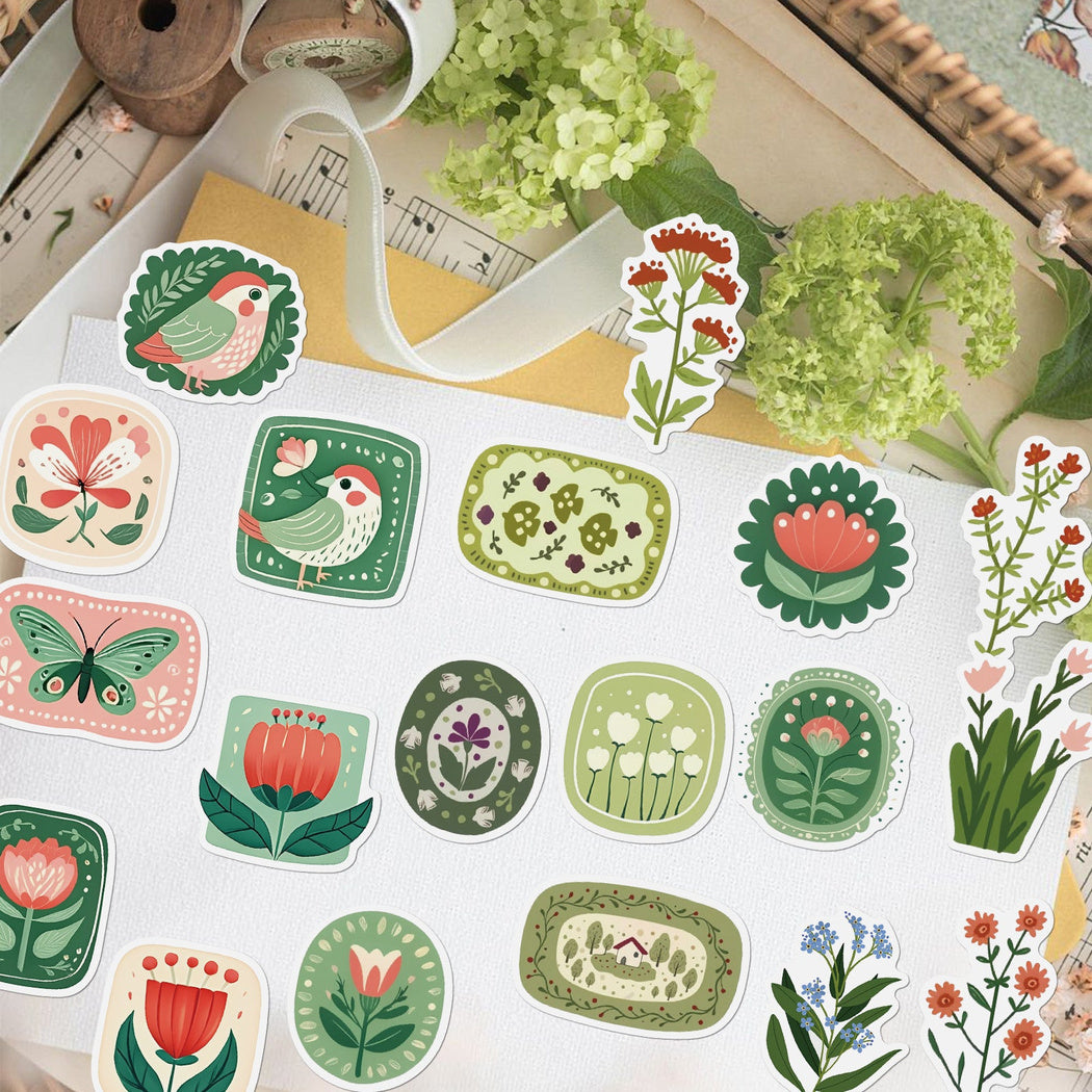 Green plant stickers arranged on a desk