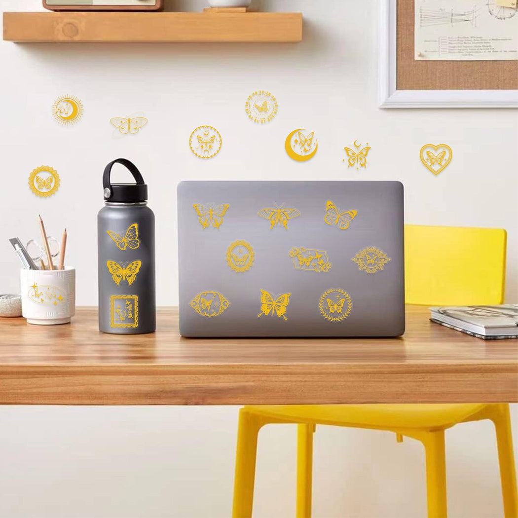 Gold botanical and insect stickers shown in use