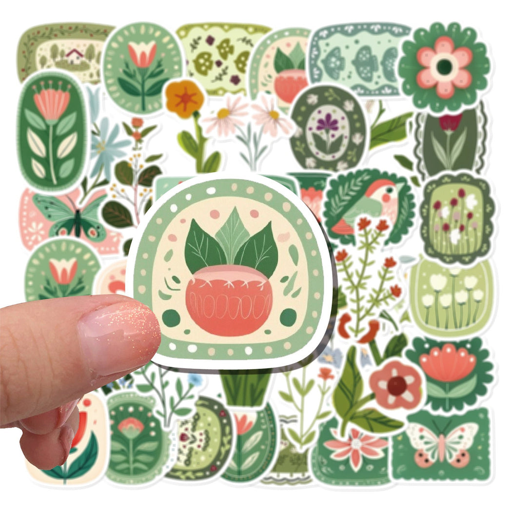 Hand holding a green plant sticker assortment