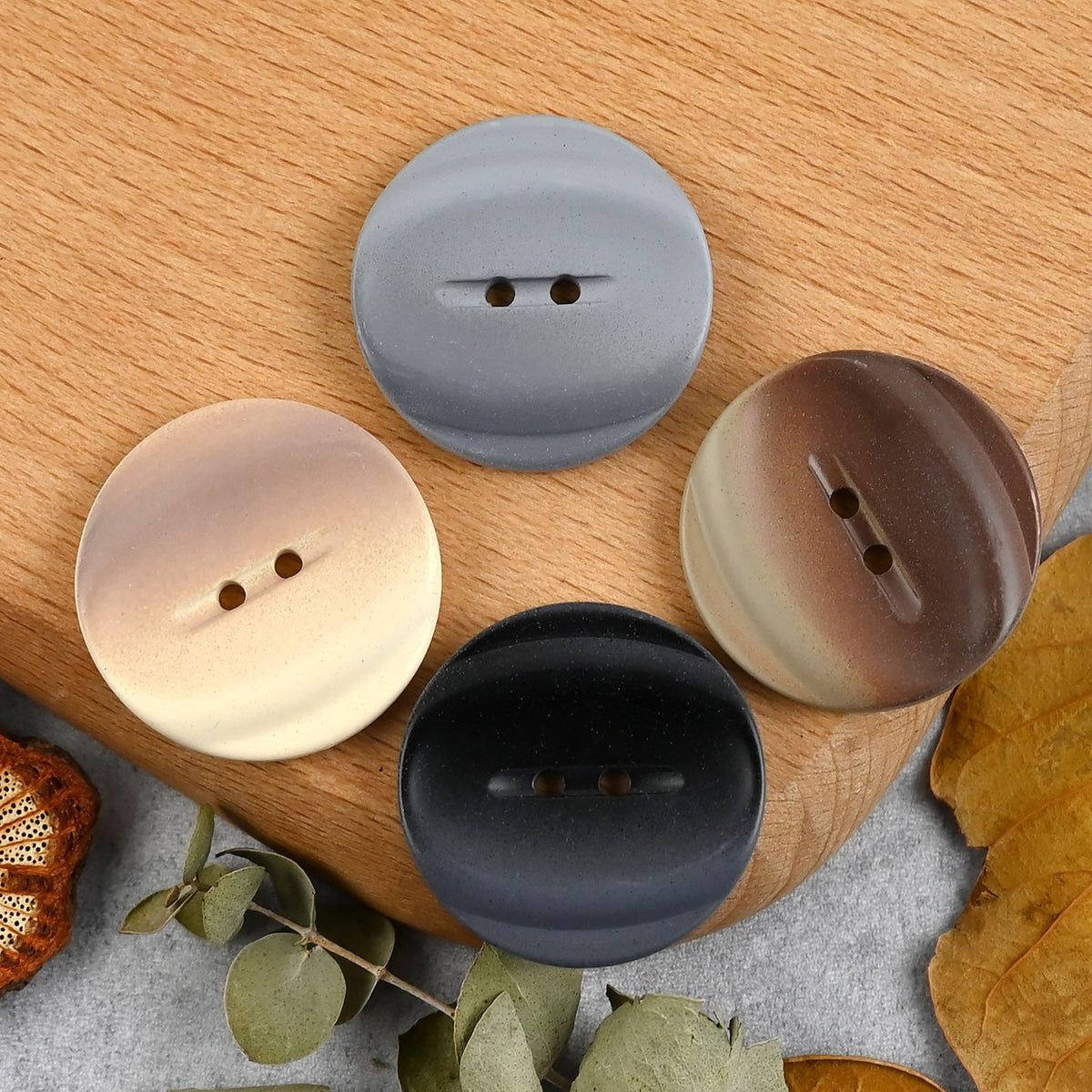 Four colors of round two-hole buttons, overhead front view