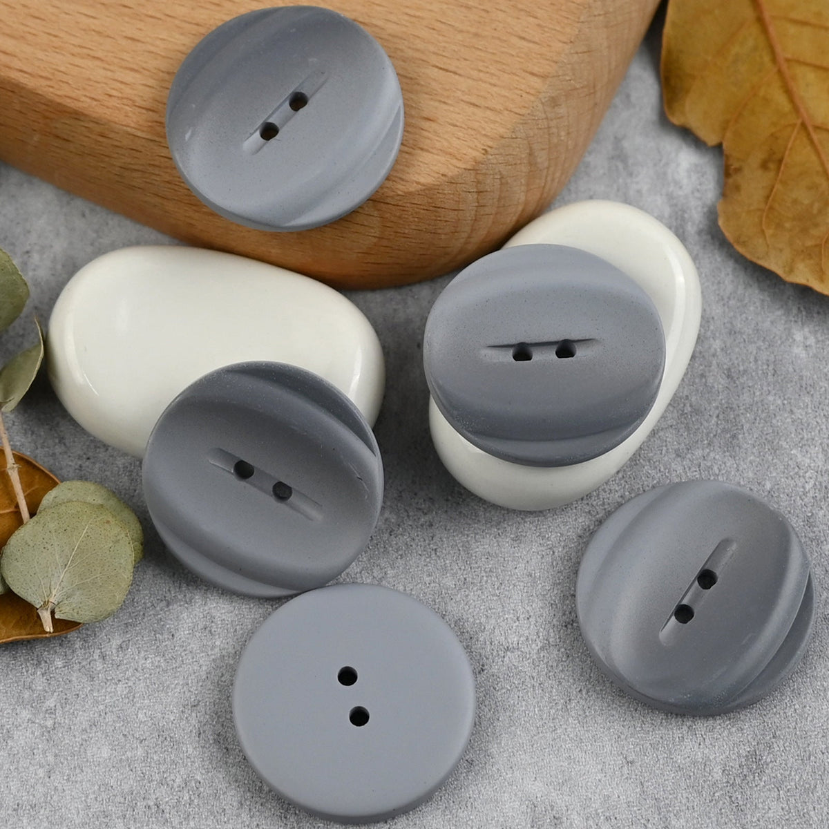 Light gray buttons with recessed two-hole channels and reverse