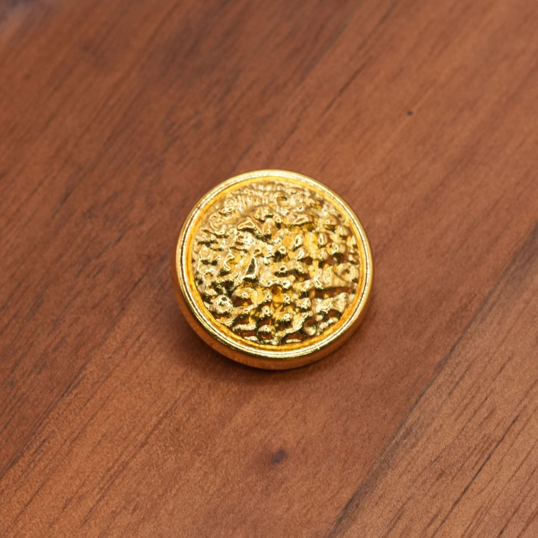 Yellow gold finish round button with an irregular textured face