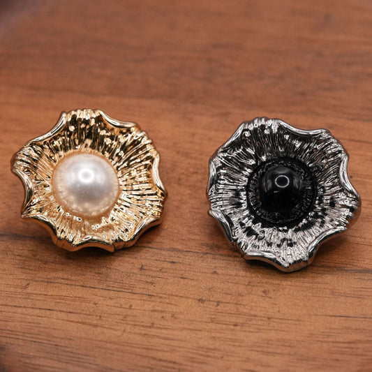 Gold-tone and silver-tone fluted flower buttons with white and black domed centers