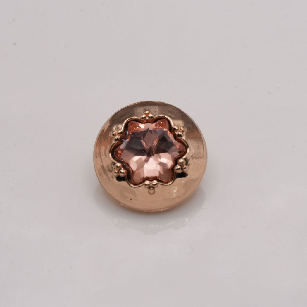Salmon-pink star-center button with a gold-tone round rim