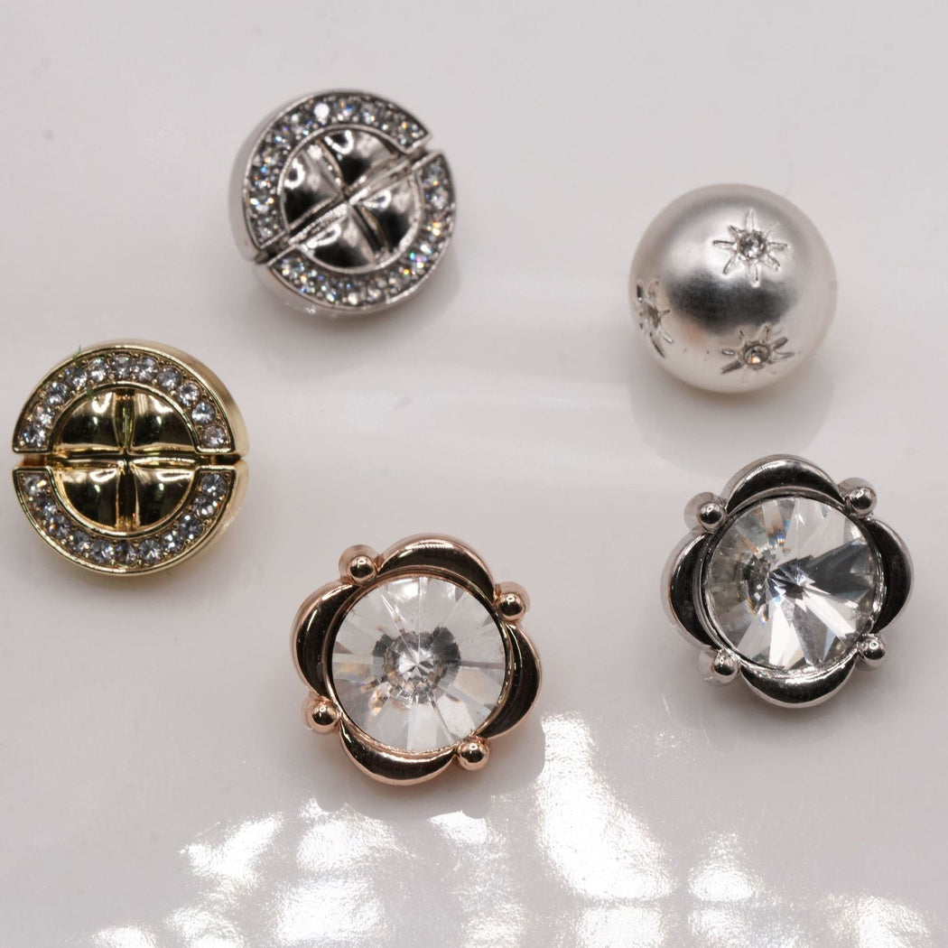 Five decorative button styles with segmented discs, faceted centers and a starburst dome