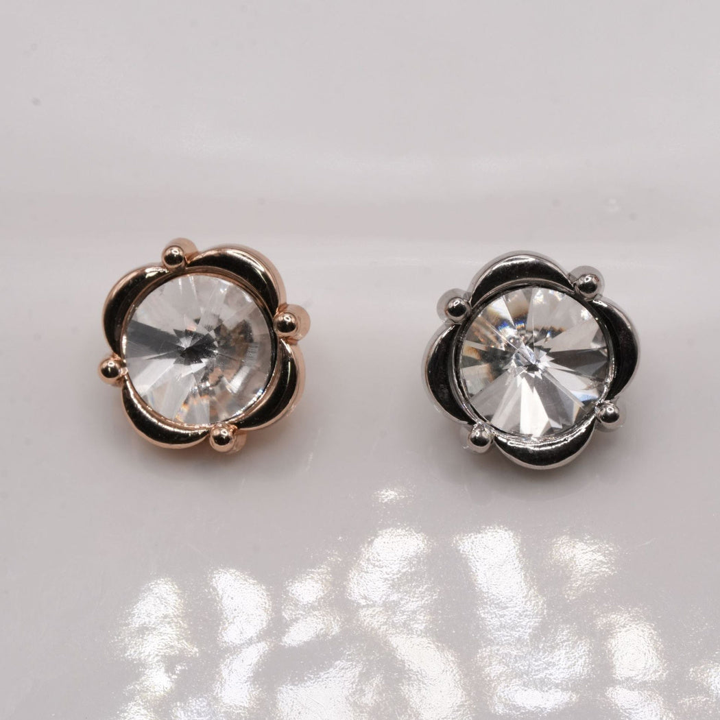 Warm-tone and silver-tone four-lobed buttons with large clear faceted centers