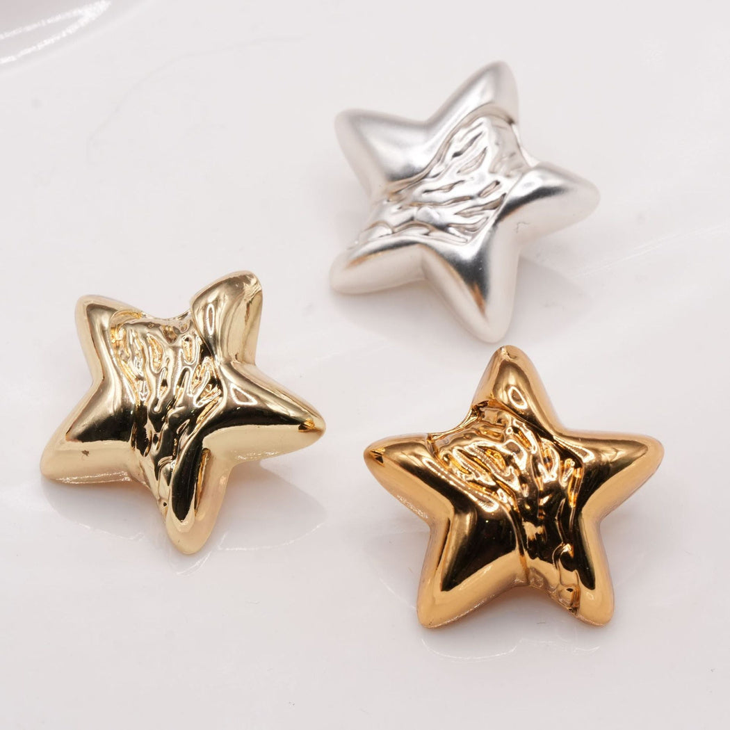 Star buttons in silver, pale gold and warm gold tones with rippled centers