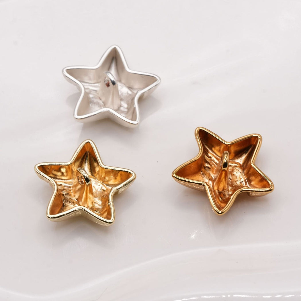 Backs of three star buttons showing central shank loops