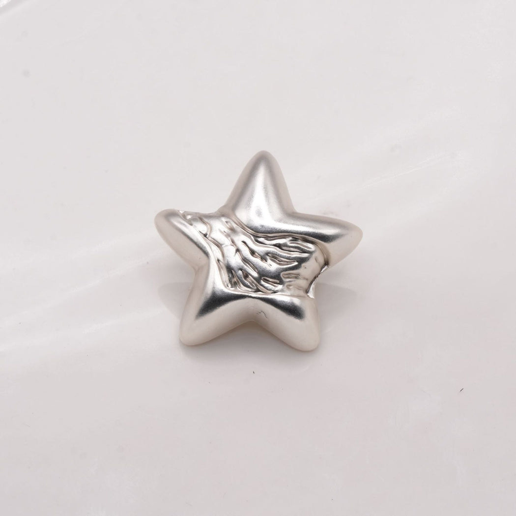 Silver tone star button with a rippled front surface