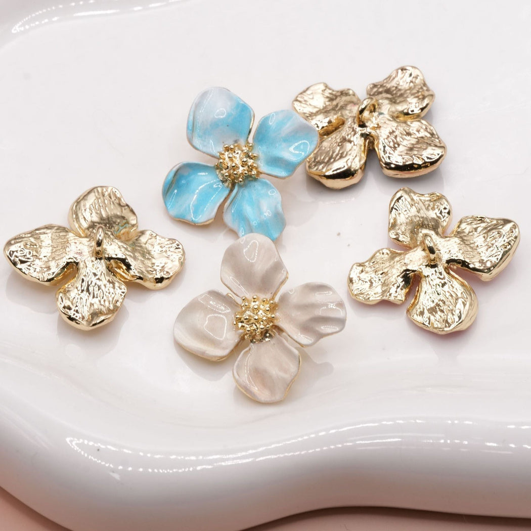 Blue and cream flower button fronts beside three gold-tone shank backs
