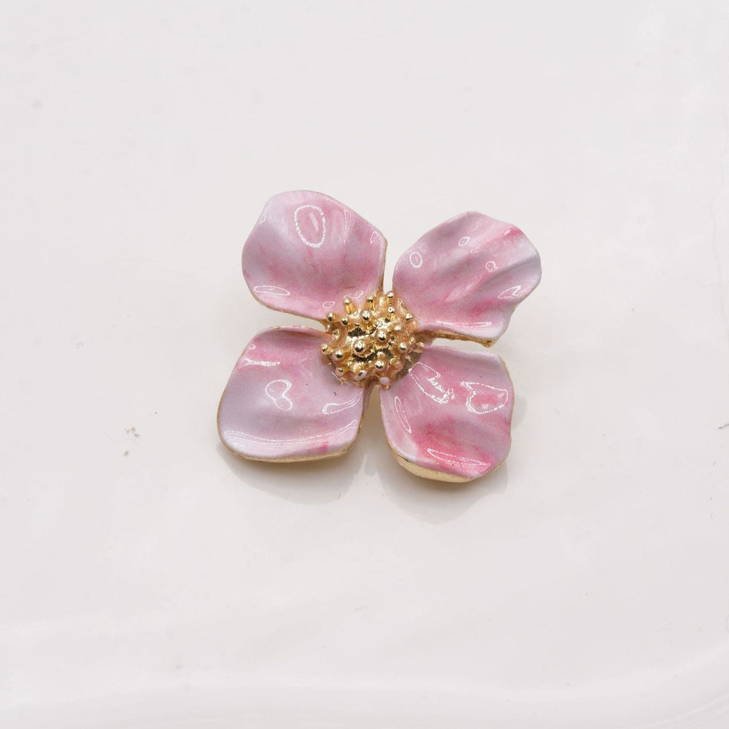 Pink and white four-petal flower button with a raised gold-tone center