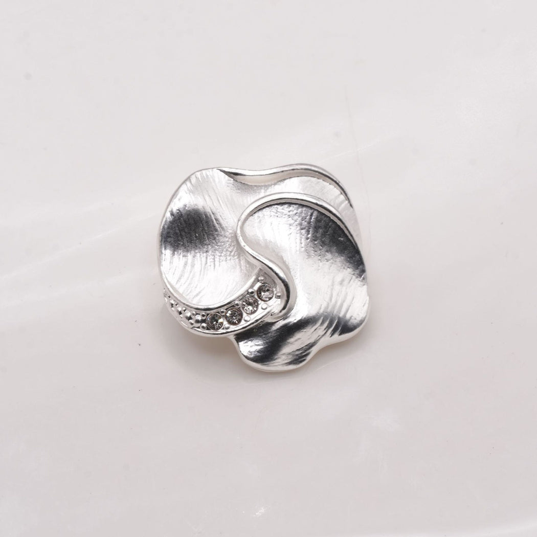 Silver tone lobed button with a curved ridge, front view