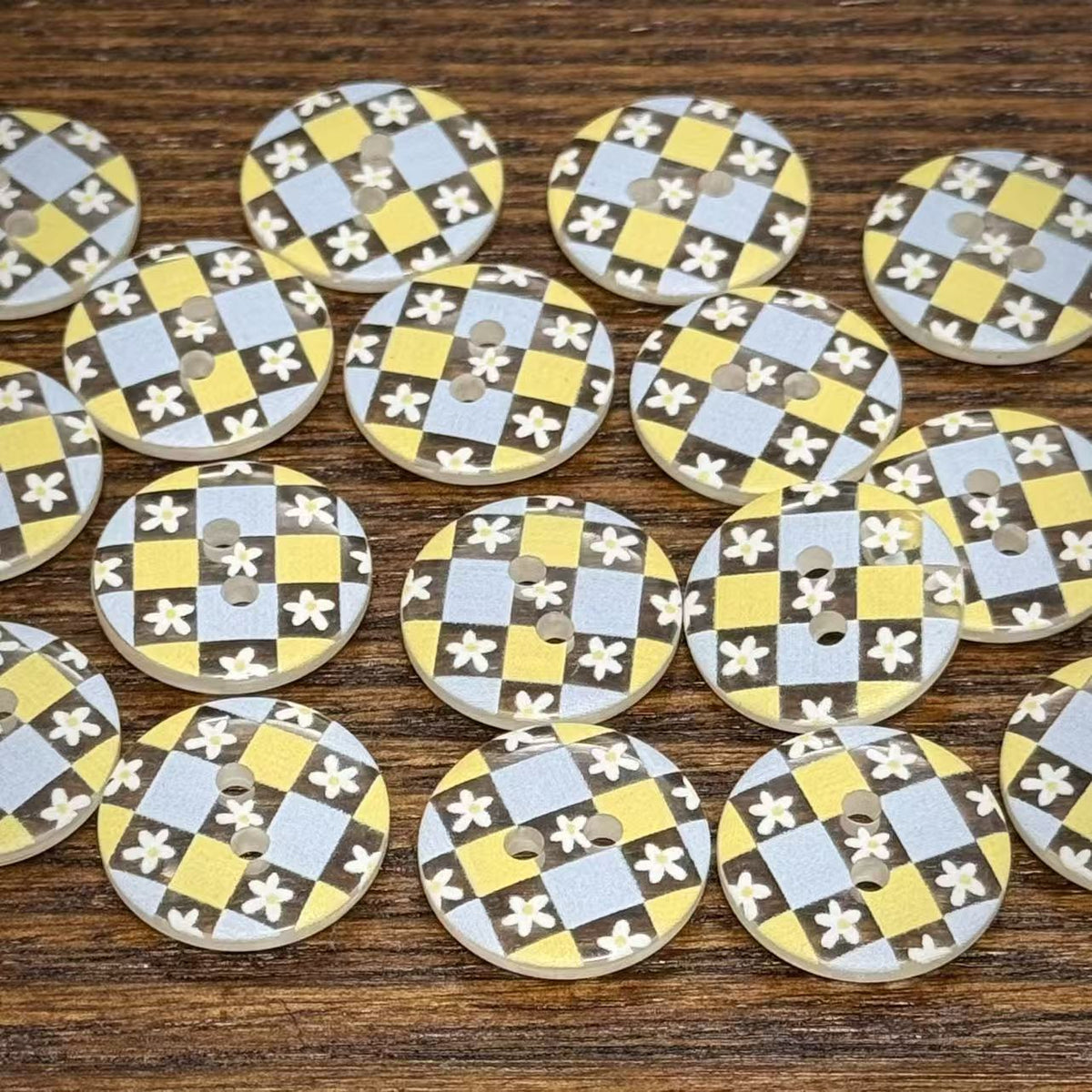 Floral check two-hole buttons arranged on a neutral surface