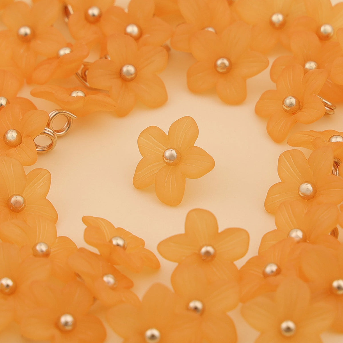 Bright orange five petal shank buttons