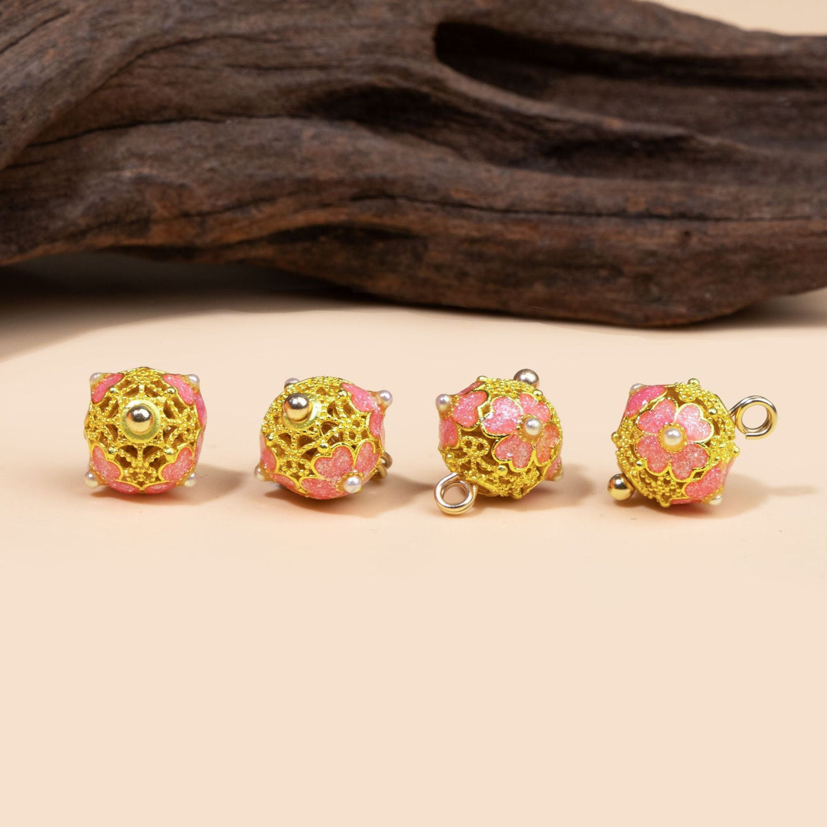 Pink filigree floral dome button from four angles