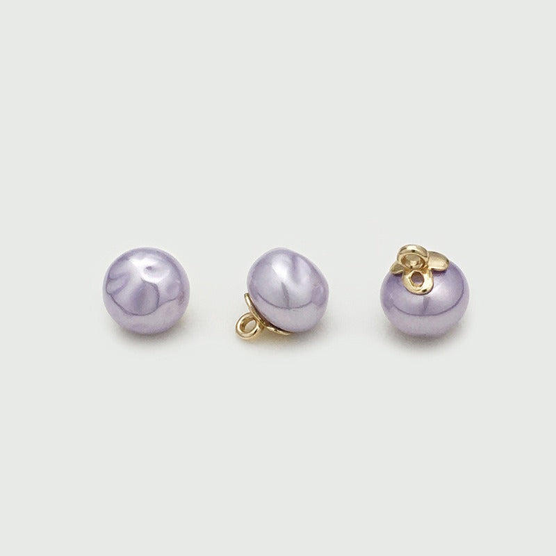 Purple rippled orb button shown from three angles