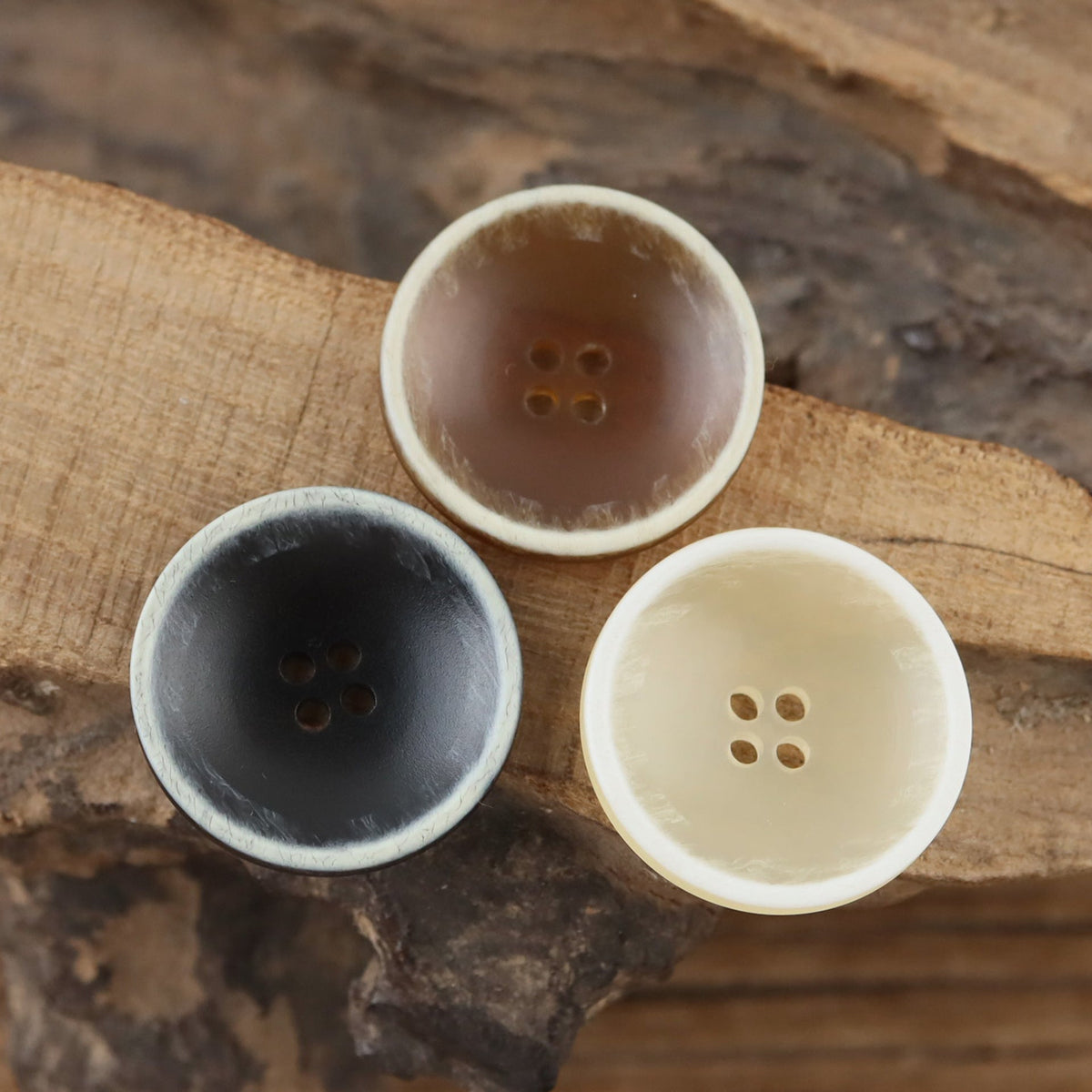 Three contrast rim bowl buttons in brown black and ivory