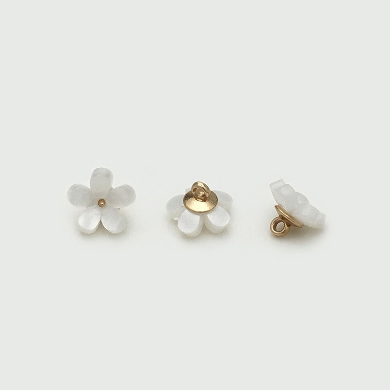 White five petal bloom button from three angles