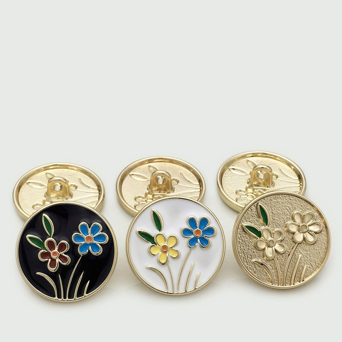 Three round flower motif shank button styles shown with matching backs