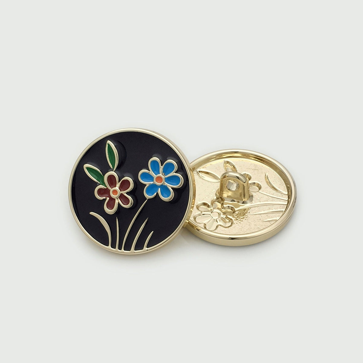Black round button with colorful flower motif, shown front and back