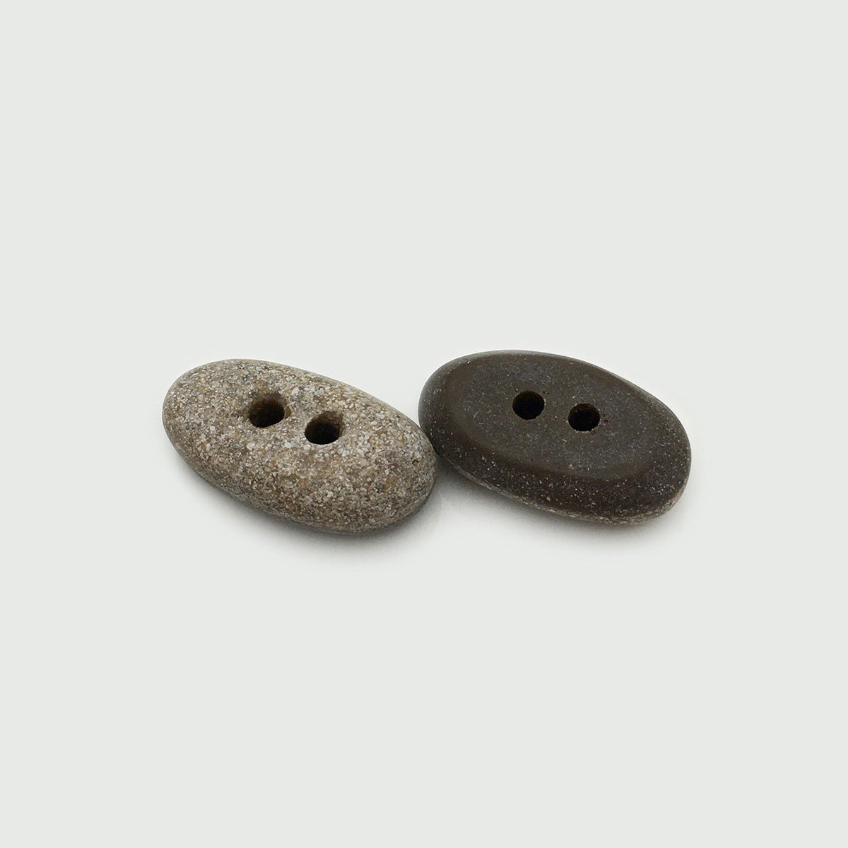 Two brown oval two-hole buttons in speckled and solid styles