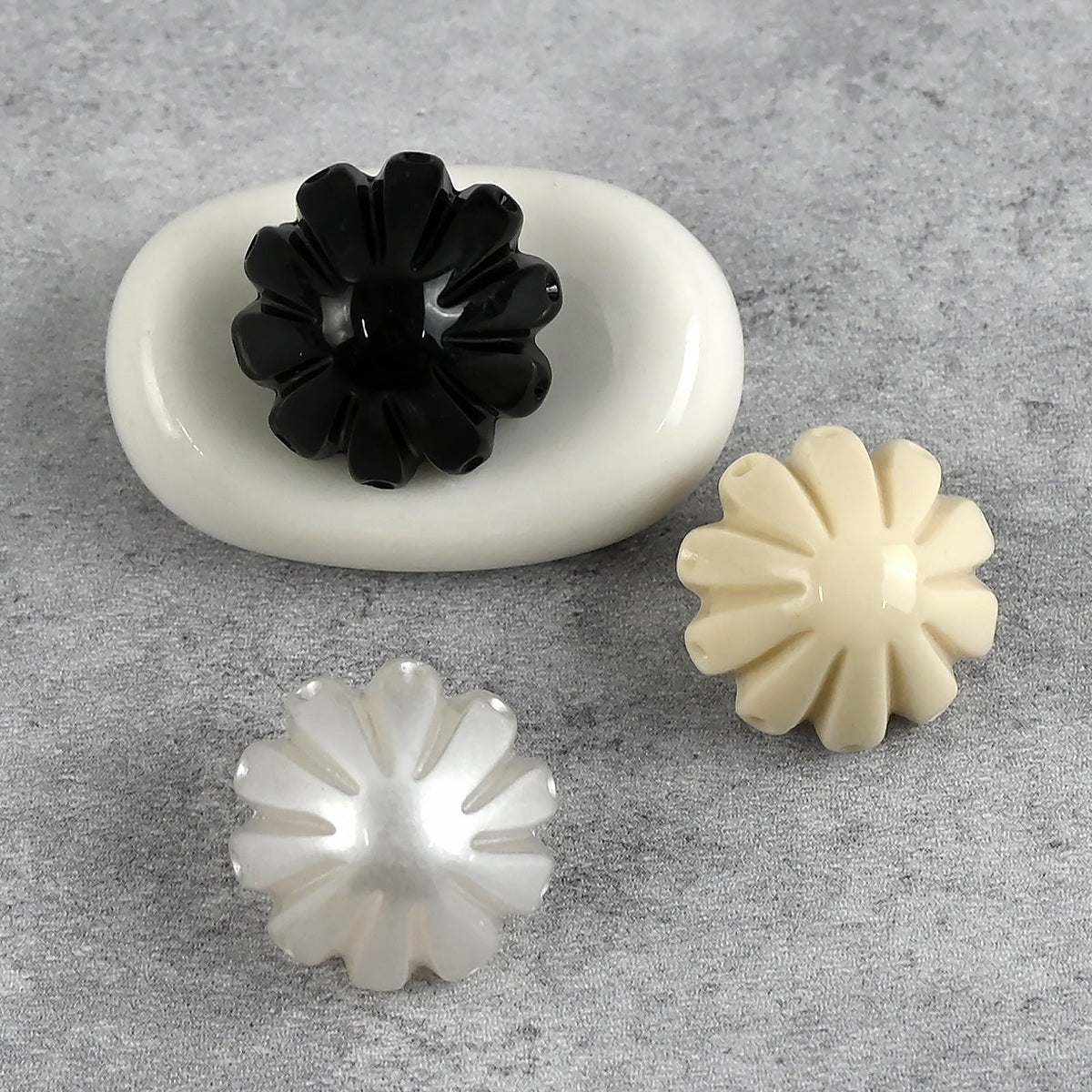Black, cream, and white fluted dome shank buttons