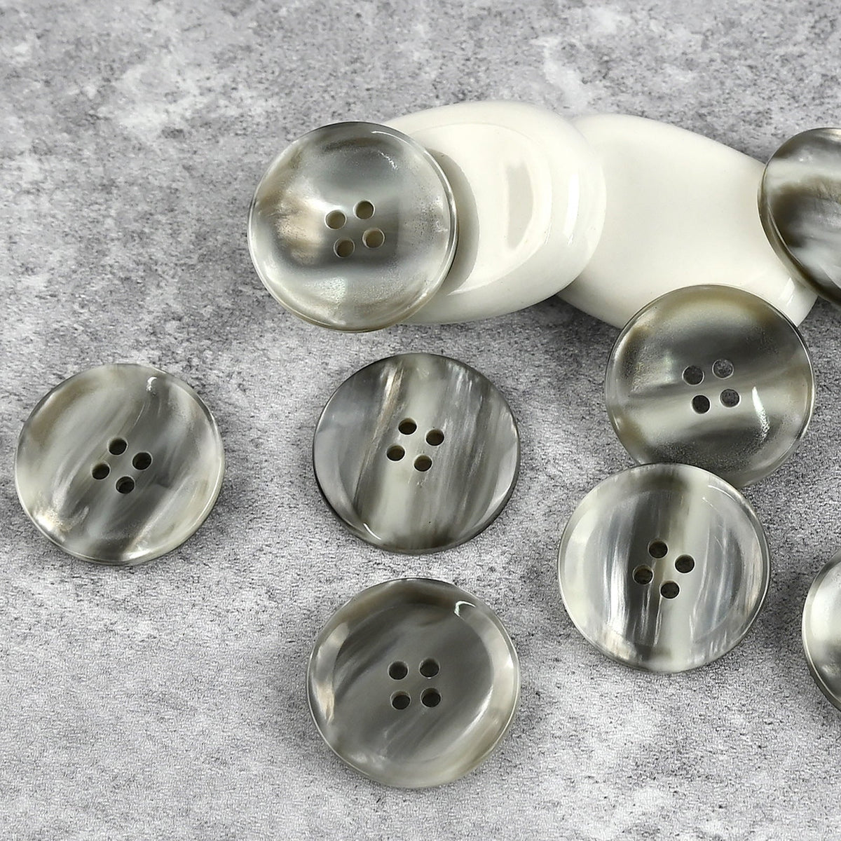 Gray and white swirled four-hole buttons with a soft sheen