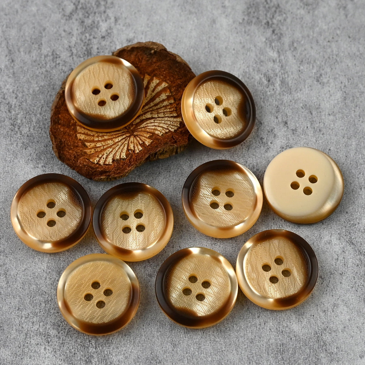 Orange four-hole buttons with herringbone-patterned centers