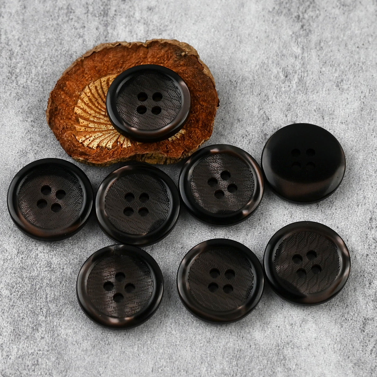 Dark brown-black four-hole buttons with wavy rims