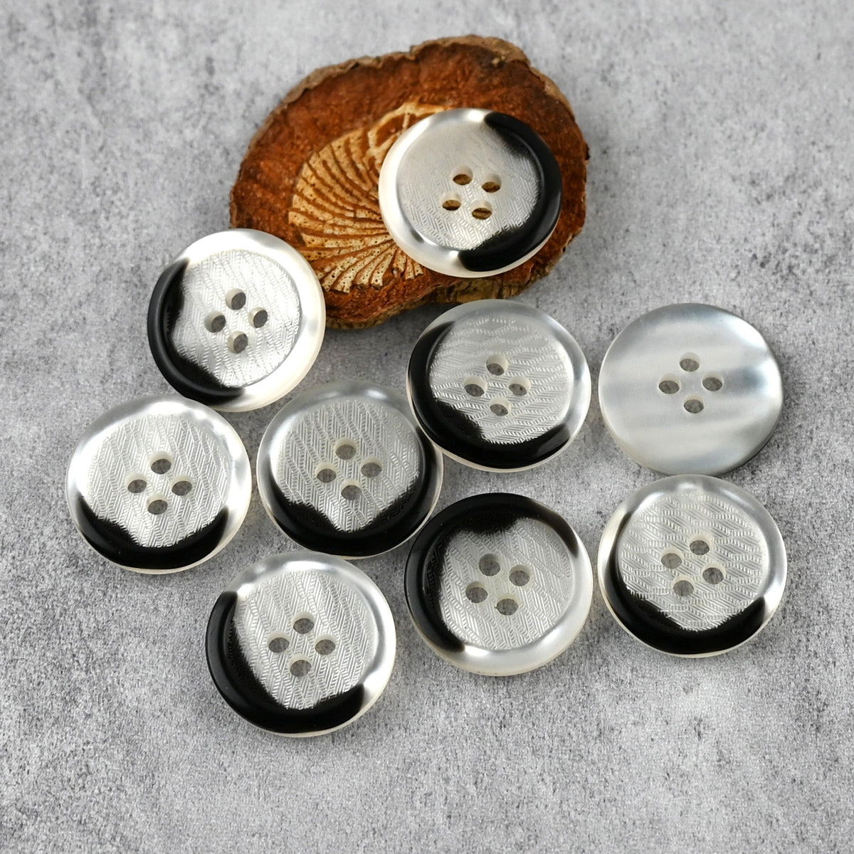Translucent white four-hole buttons with dark rim accents