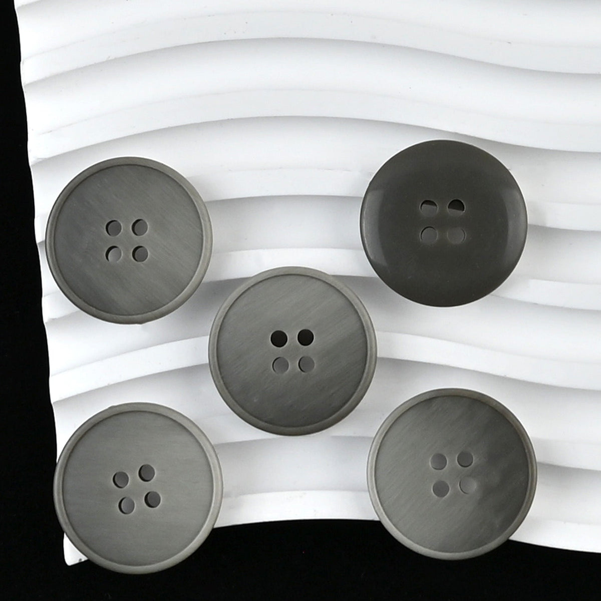Gray four-hole buttons with tonal streaked faces