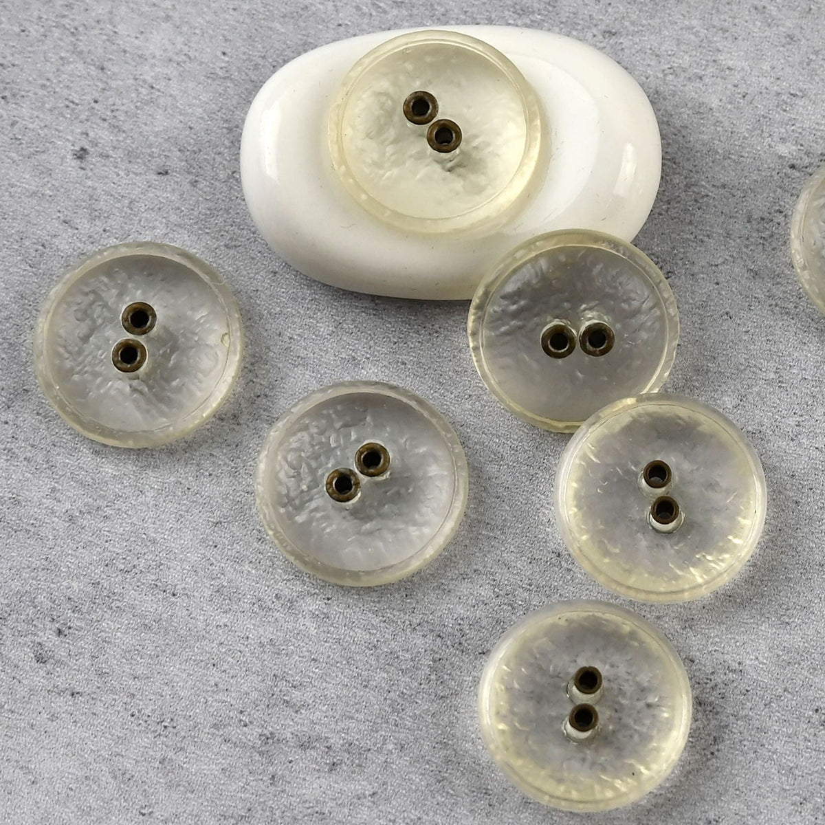 Clear two-hole textured buttons in assorted sizes
