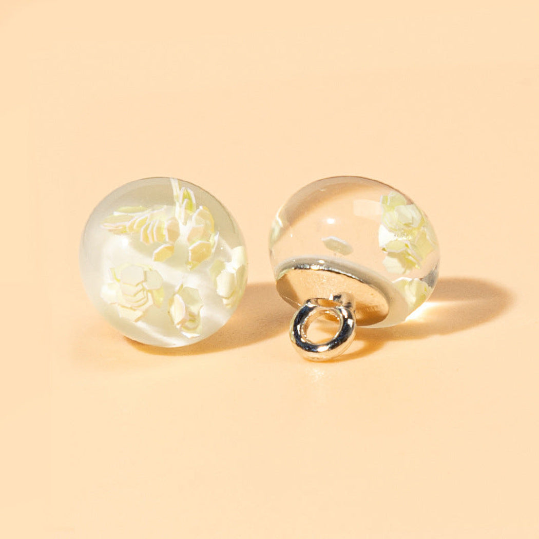 Pale yellow reflective flake orb shank button front and back
