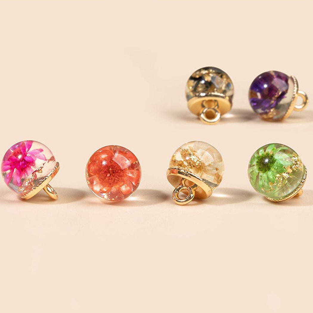 Six floral dome shank buttons in assorted colors