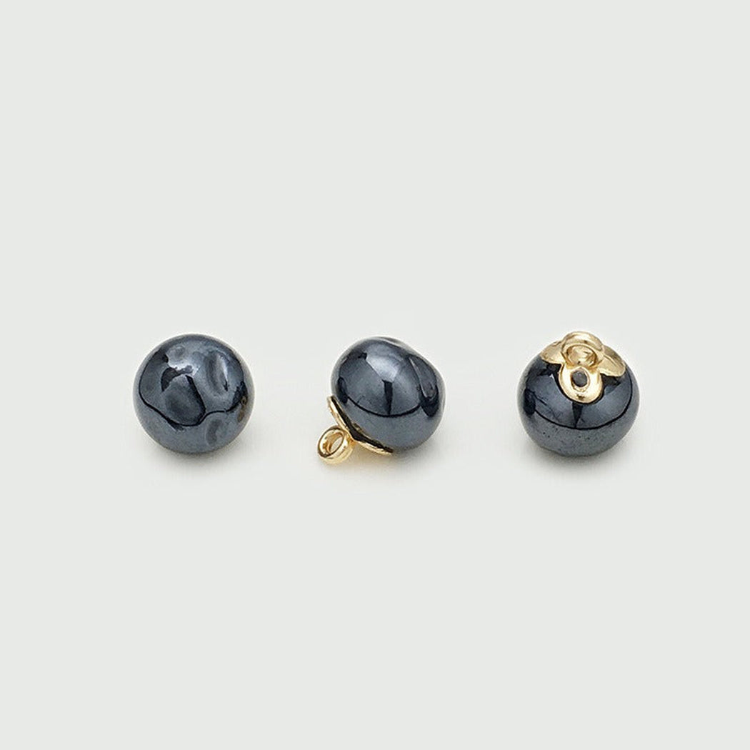 Black rippled orb button shown from three angles