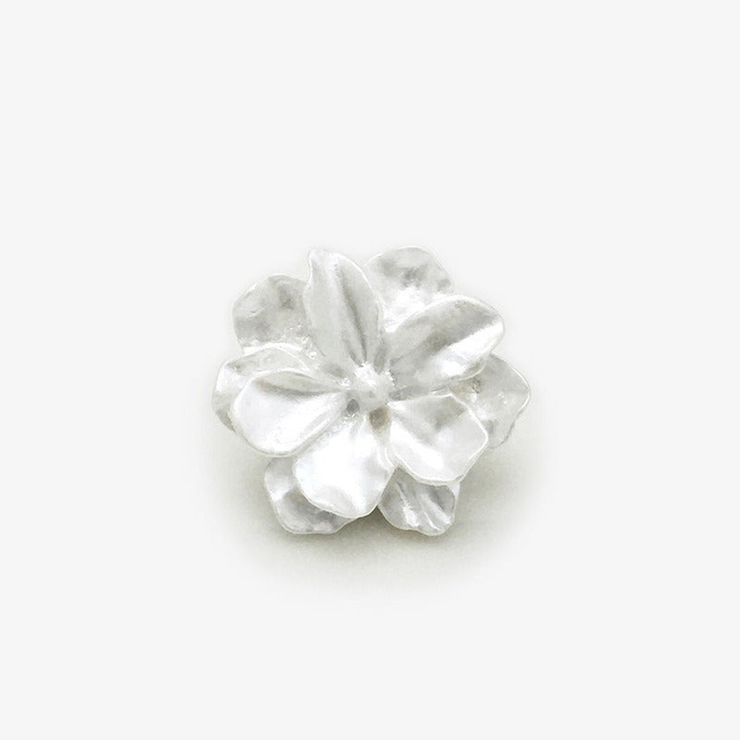 White sculpted blossom shank button front view