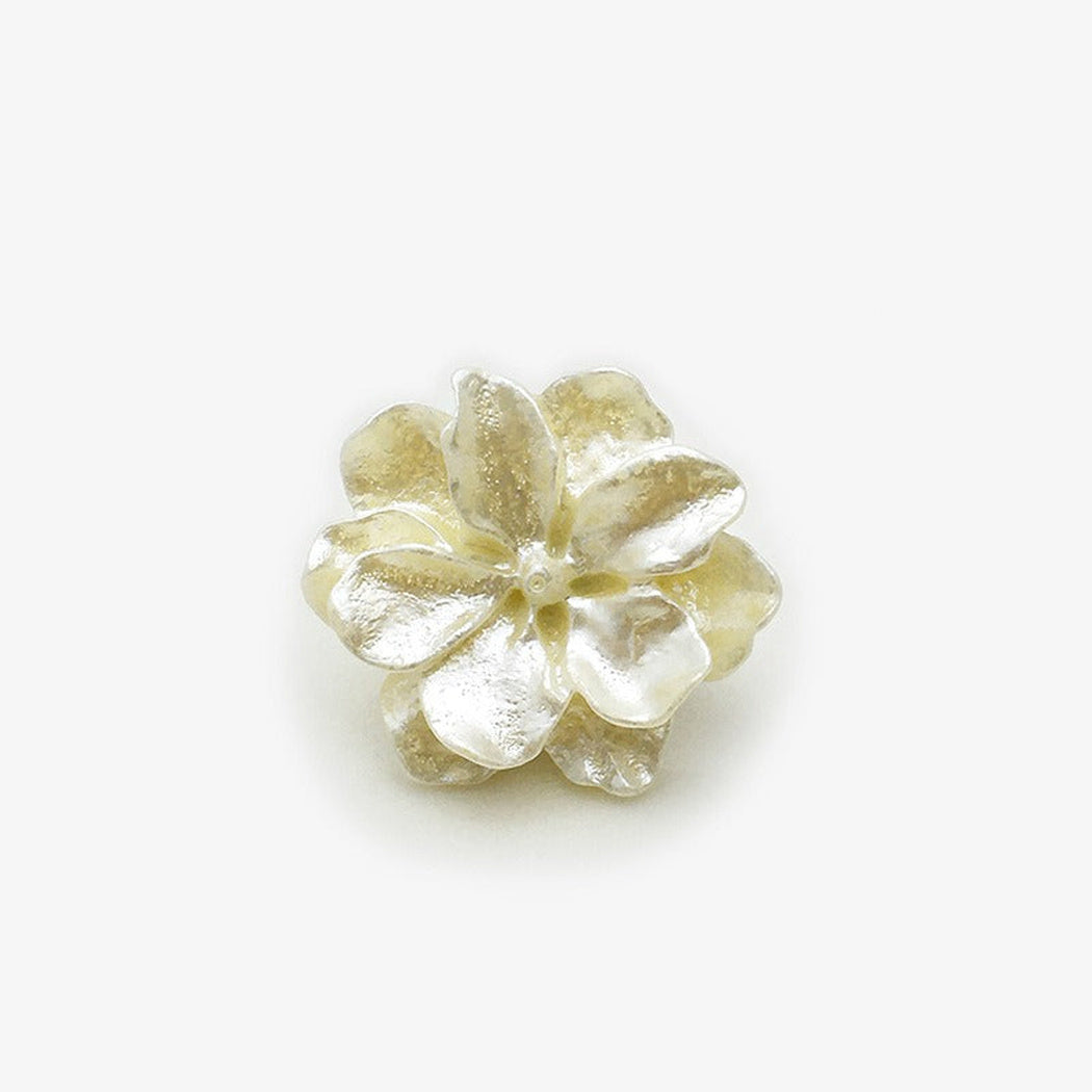 Beige sculpted blossom shank button front view
