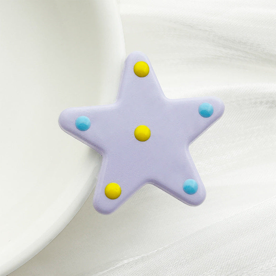 Purple polka dot star button