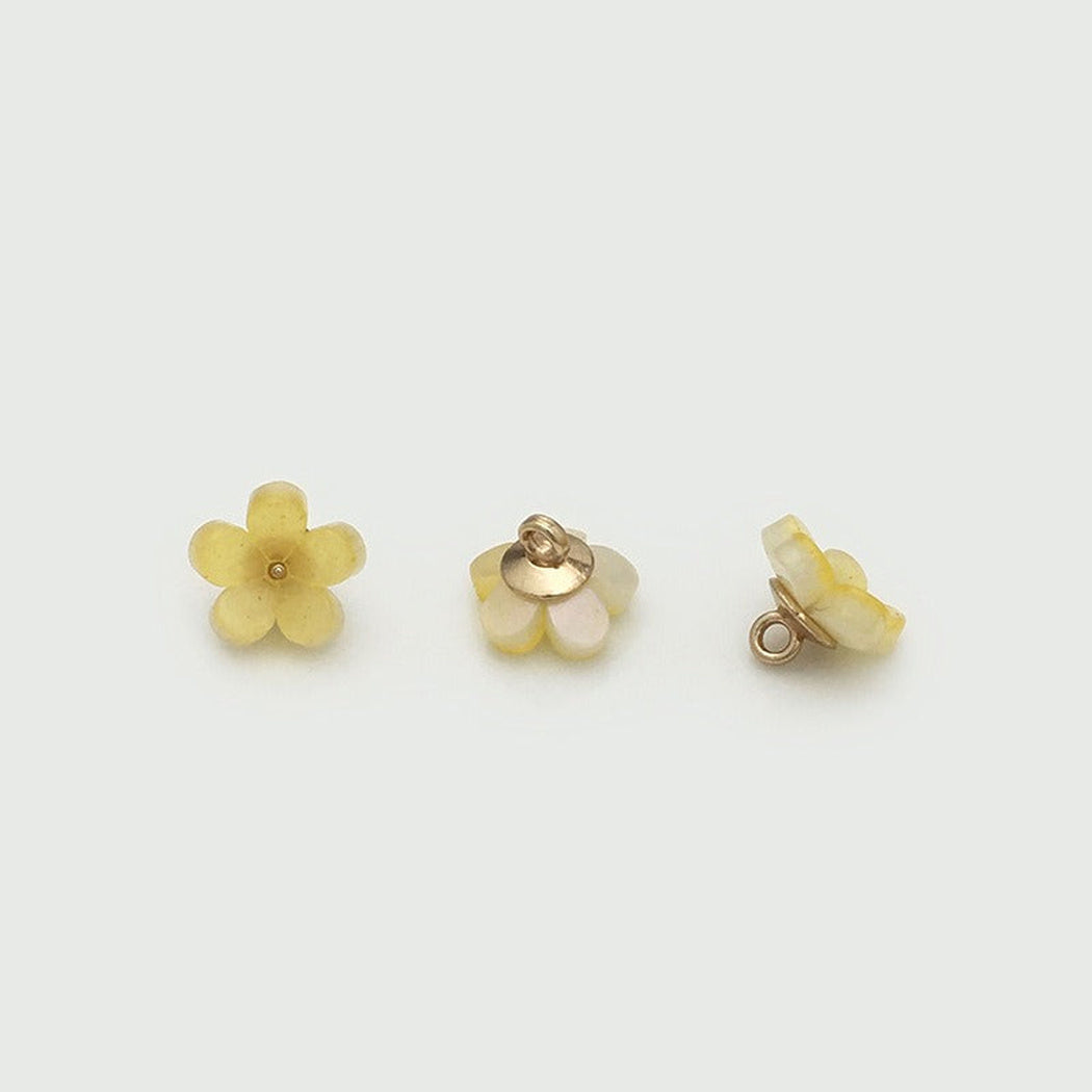 Yellow five petal bloom button from three angles