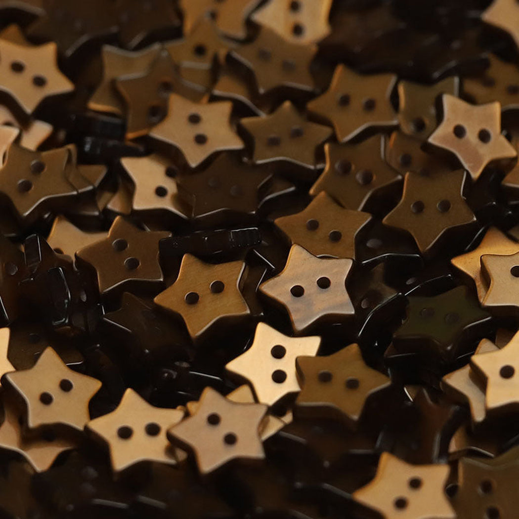 Close-up pile of brown five-point star two-hole buttons