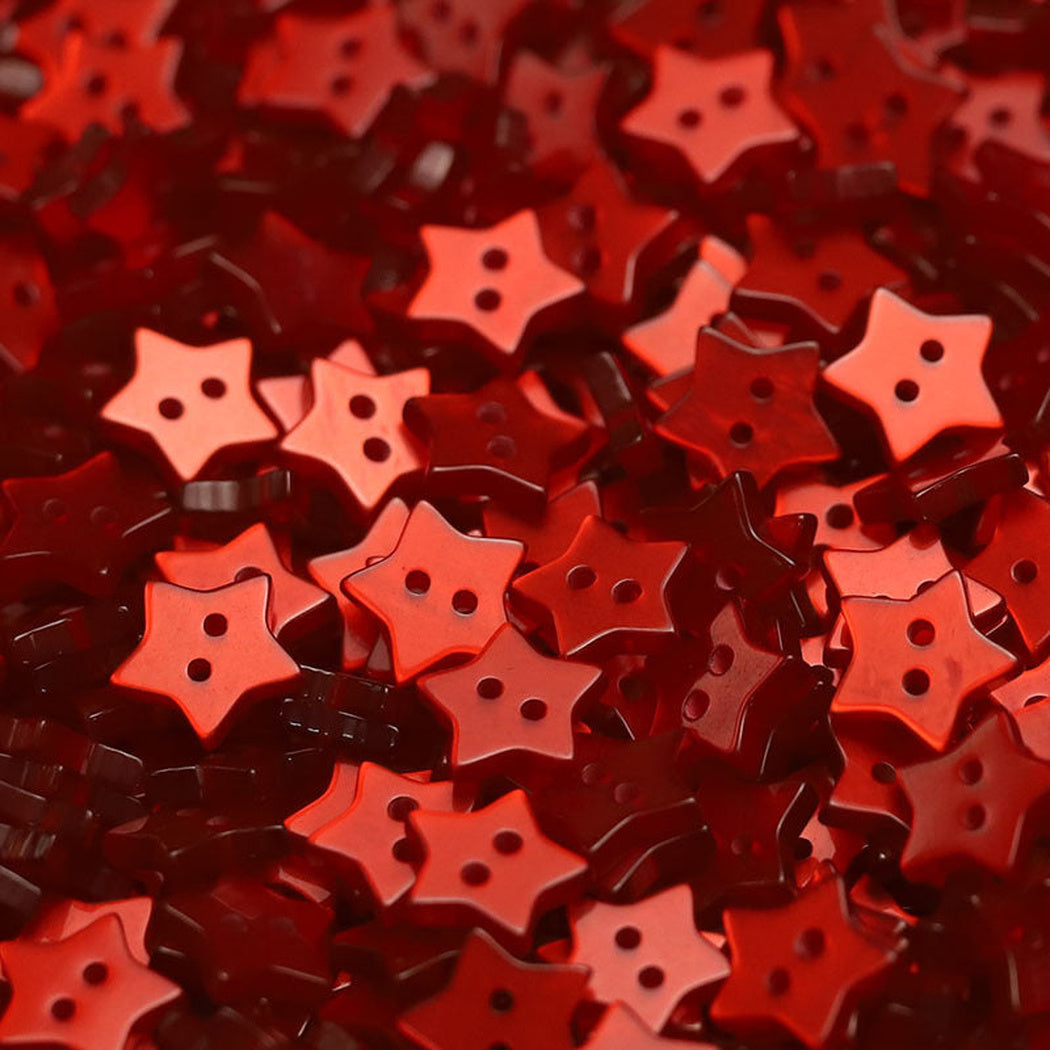 Close-up pile of red five-point star two-hole buttons