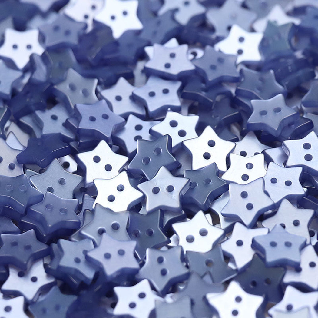 Close-up pile of sky blue five-point star two-hole buttons