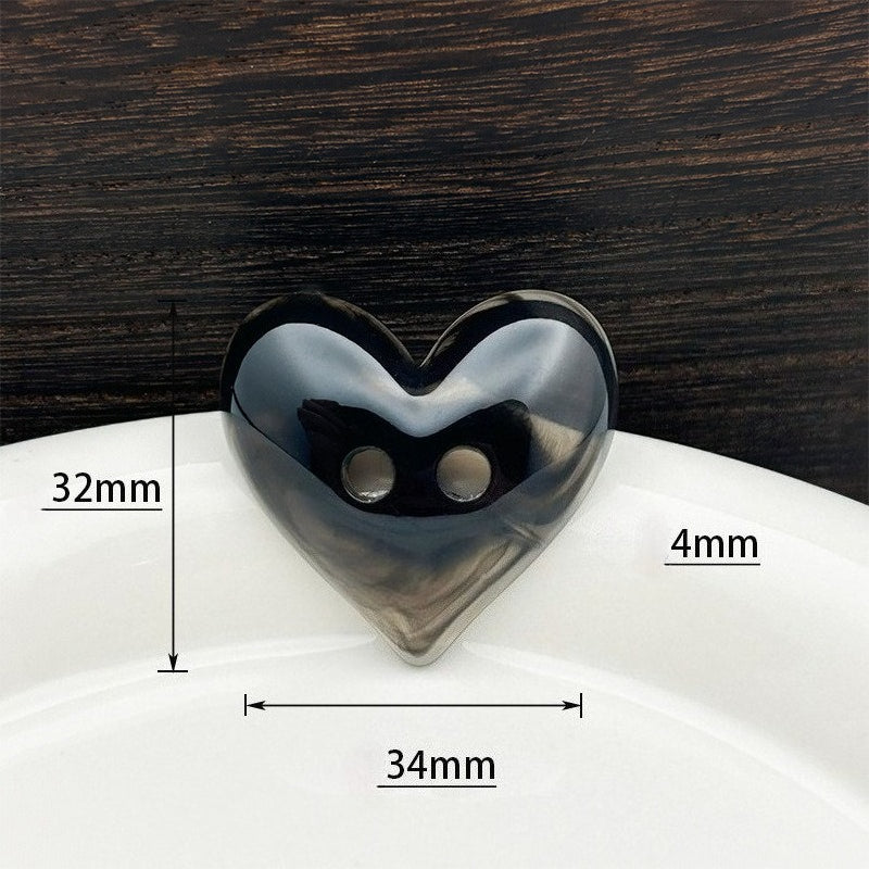 Black heart-shaped button with measurement guides